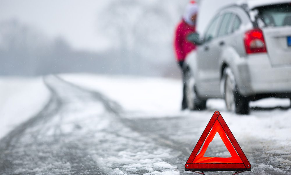 Inter Car Emergency Kit Are You Ready - Closeup of Road and Car Breakdown in Winter